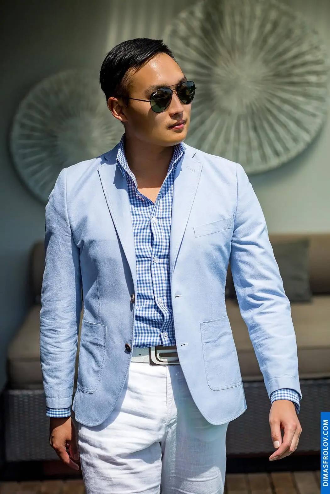 Elegant male portrait in light blue blazer and sunglasses — confident and stylish