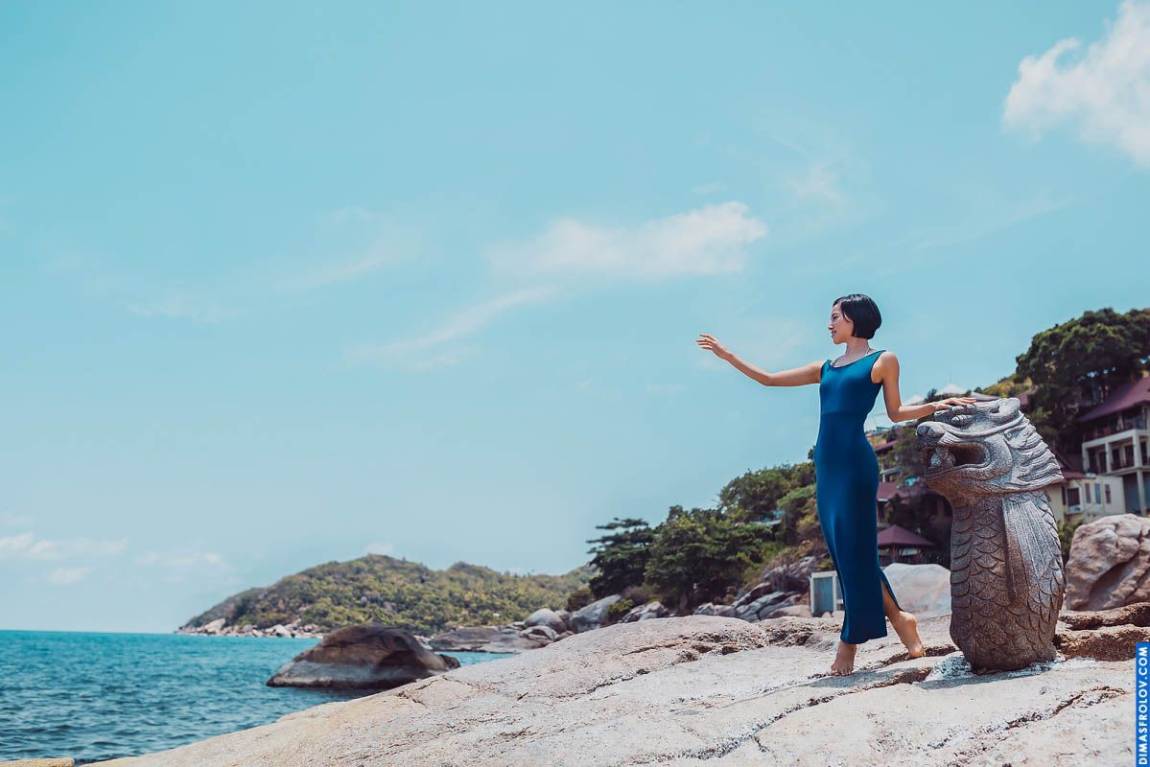 พอร์ตเทรตสบายๆ ของหญิงสาวในชุดจัมป์สูทสีน้ำเงินบนชายหาดหิน