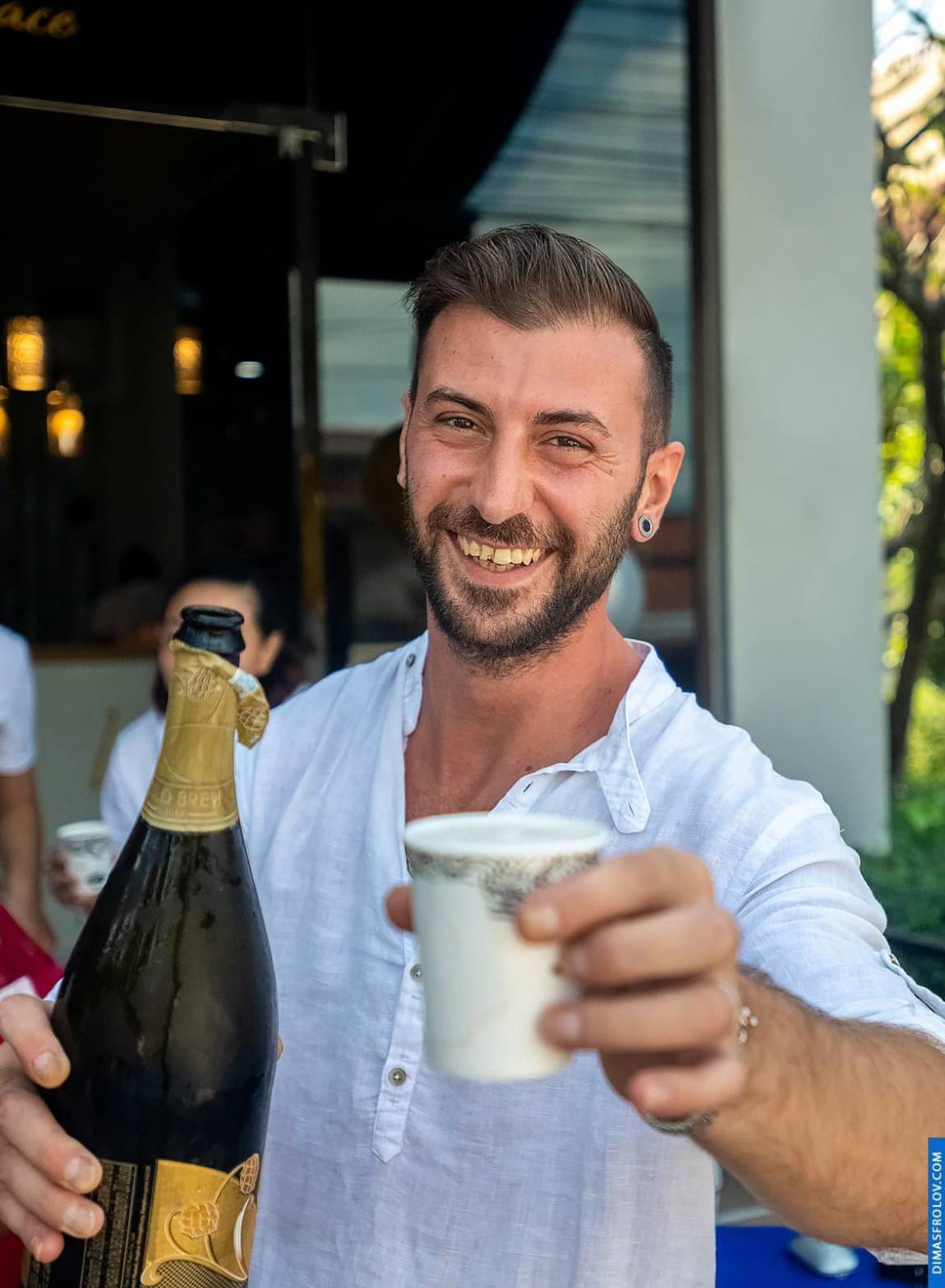 Man holding champagne and smiling during cheerful celebration
