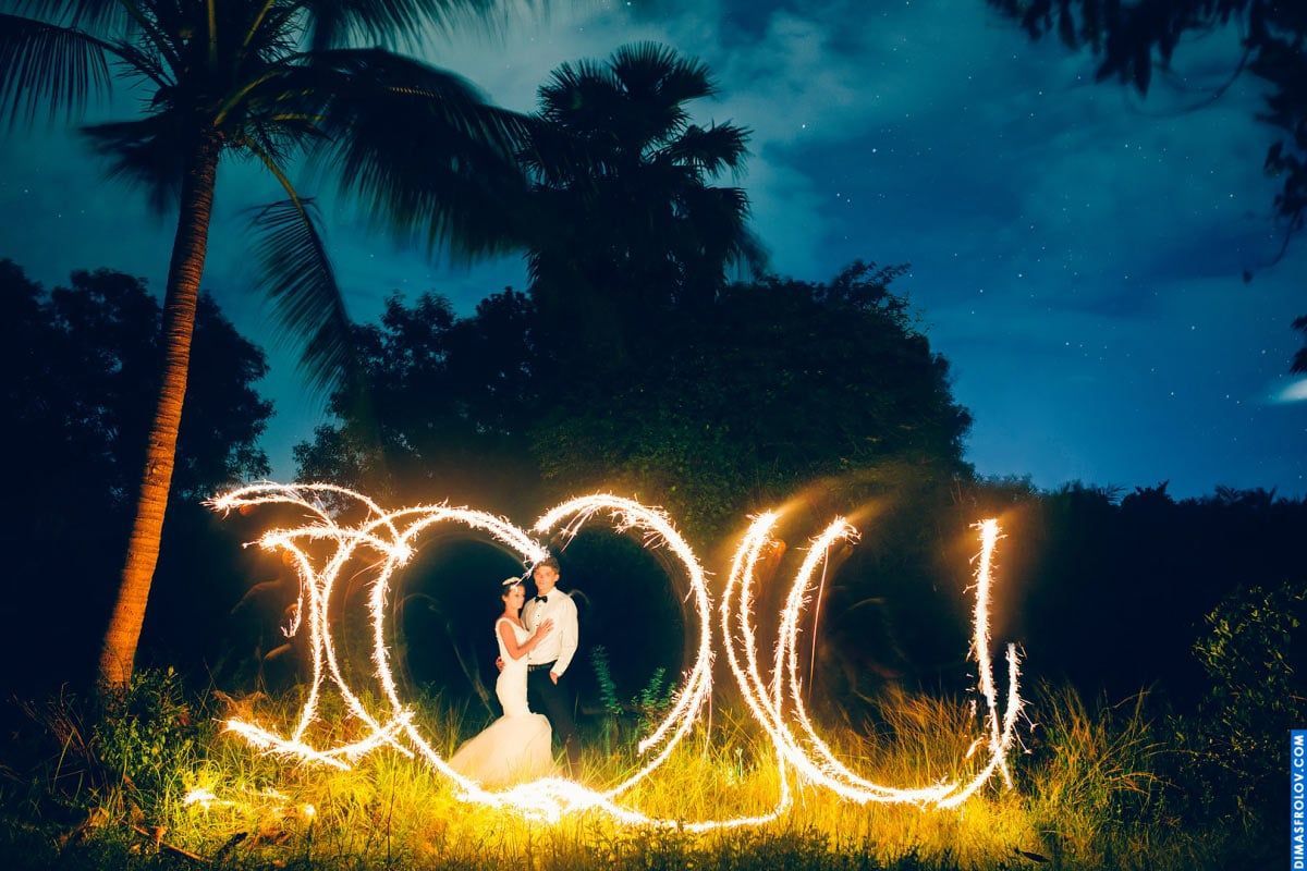 Wedding couple in sparkler light painting — magical moment from night shoot