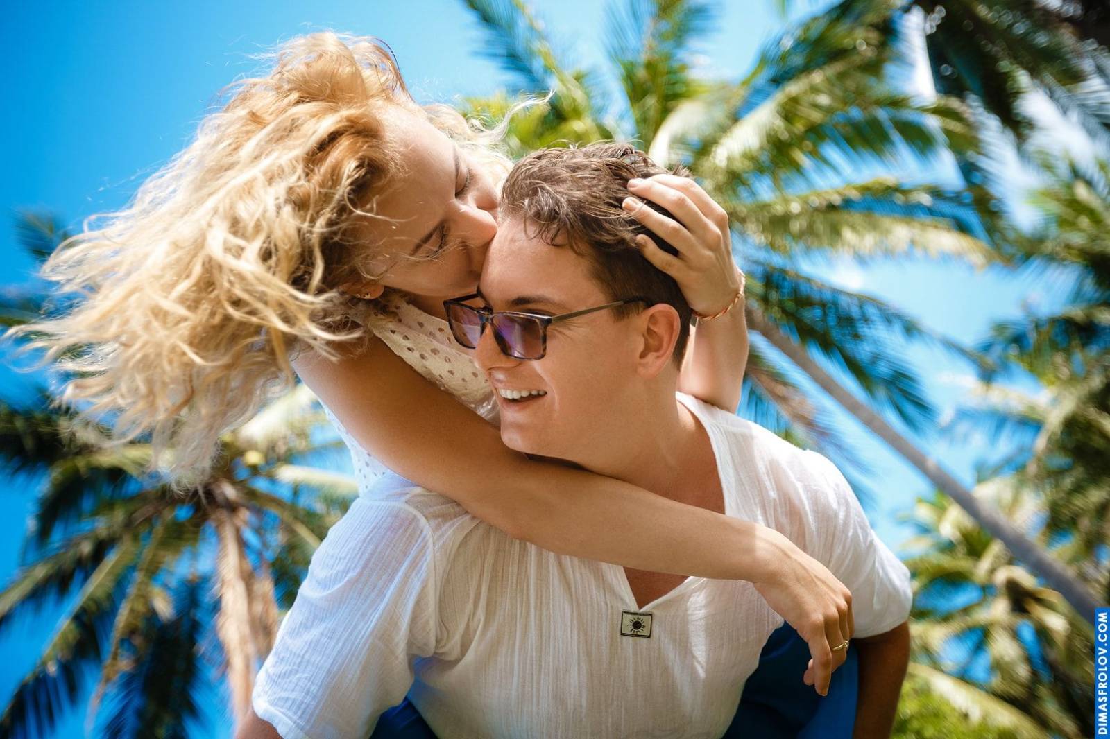 Joyful embrace in a sunlit couple photo shoot