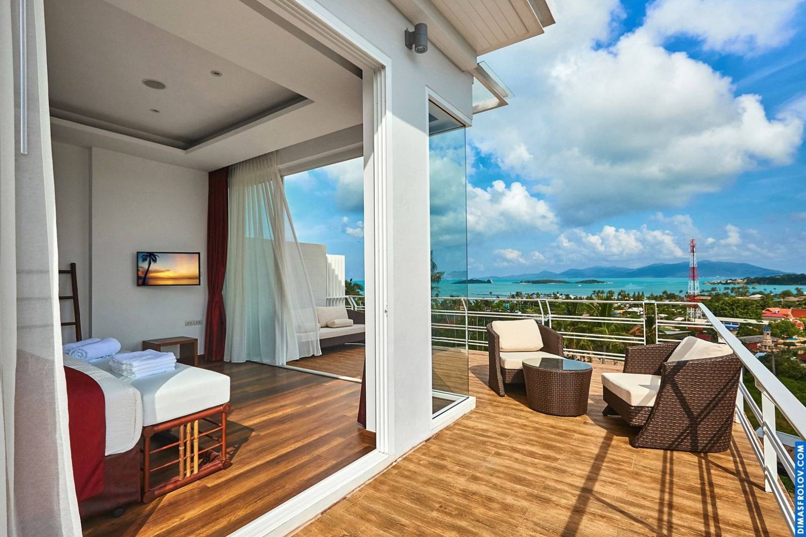 Hotel room with balcony: comfortable outdoor seating and scenic tropical view