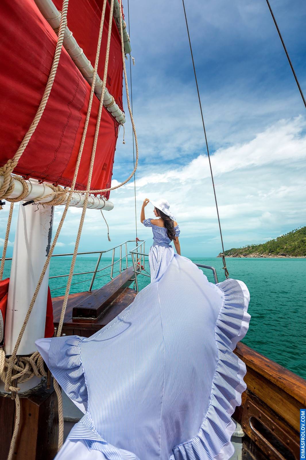 Lady in a long flowing dress during an elegant boat photo shoot