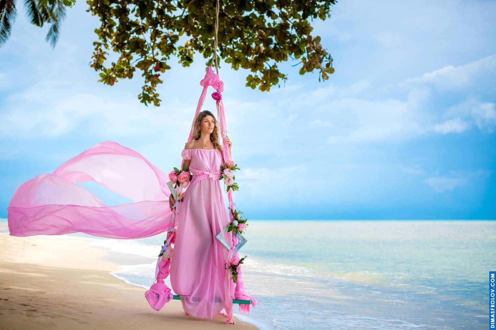 Dreamy fairy-tale style shoot with a girl in a pink dress by the sea