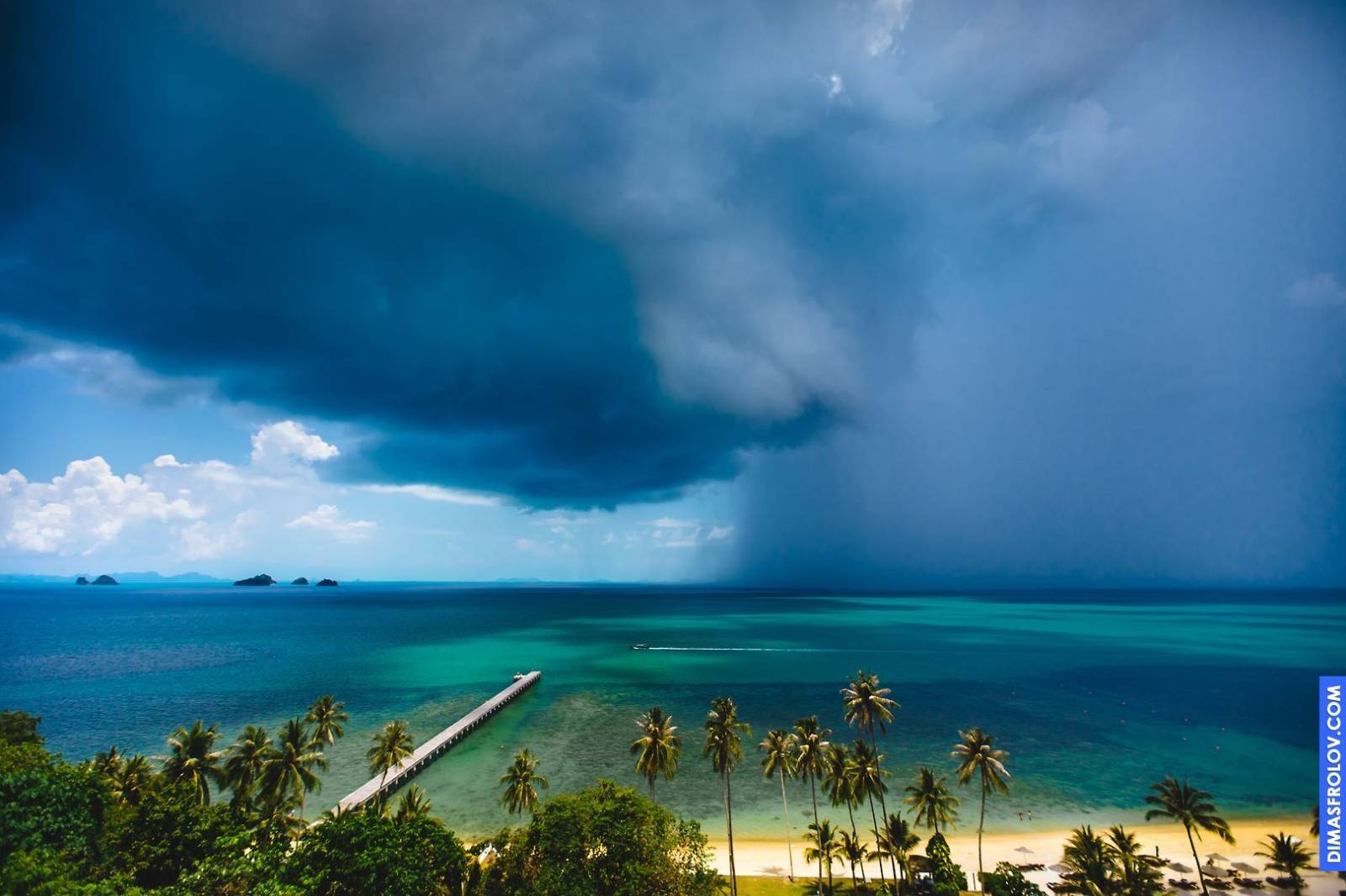 Dramatic coastal landscape with a long pier stretching out into a stormy sea under a dark, cloudy sky