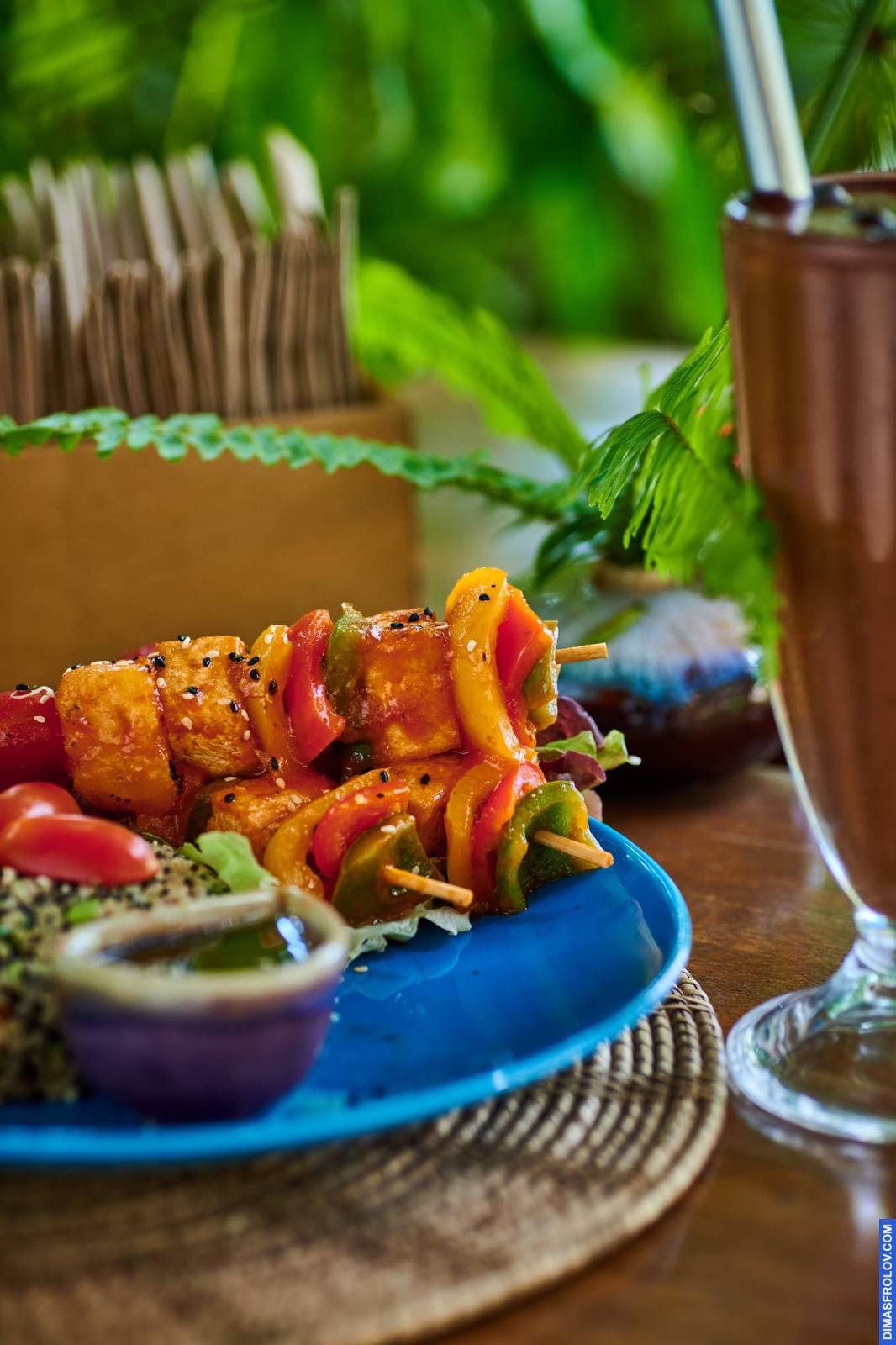 Life-style food photography with natural light showcasing grilled skewers with vegetables and a dipping sauce, ideal for sharing by restaurants and food bloggers on social media