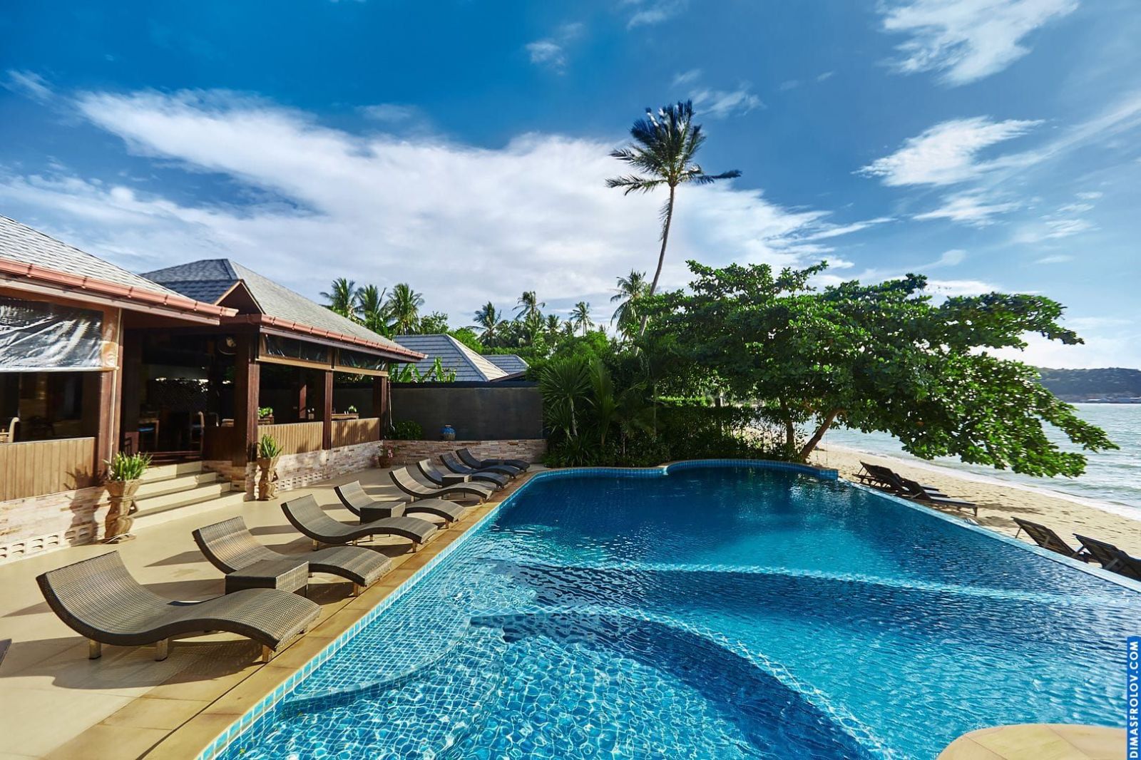 Luxury hotel pool and villas: serene tropical setting with elegant architecture