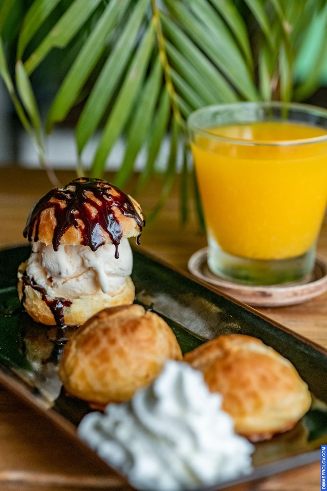Life-style food photo in natural light featuring a gourmet burger with dessert and orange juice, ideal for Instagram by restaurants aiming for a real food aesthetic