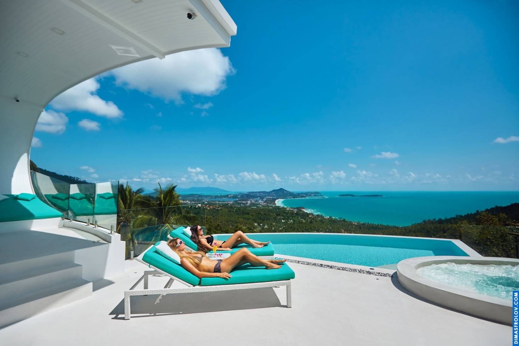 Luxury hotel terrace: woman relaxing by the infinity pool with ocean views
