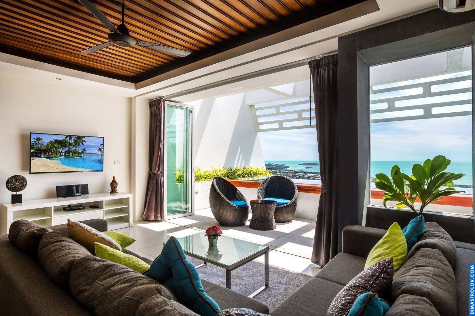 Luxury hotel suite: spacious bedroom with sitting area and ocean view balcony