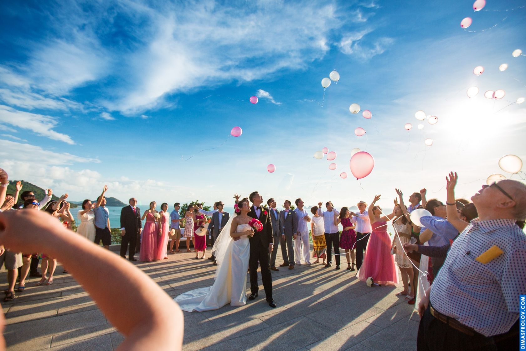Wedding celebration with guests releasing balloons into the sky — joyful moment