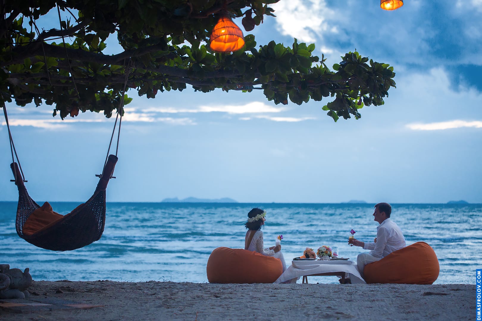 Romantic beach dinner setup for couple during engagement or honeymoon shoot