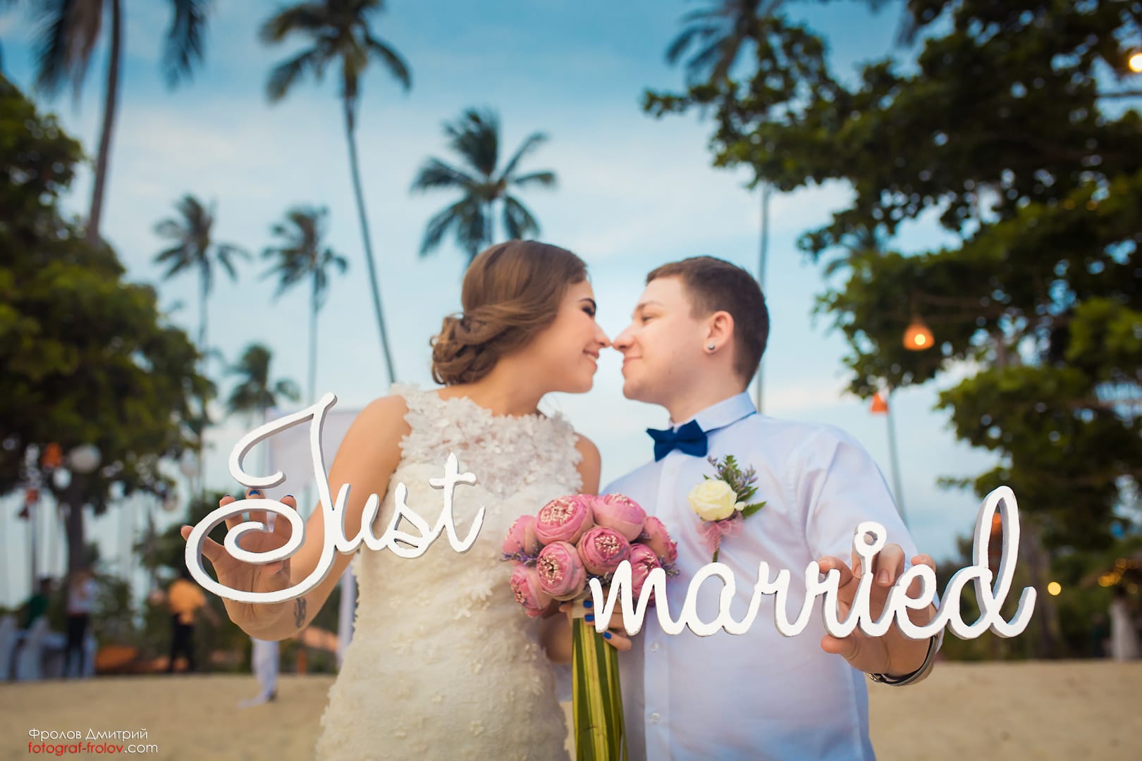 Just married couple celebrating on the beach — joyful destination photoshoot