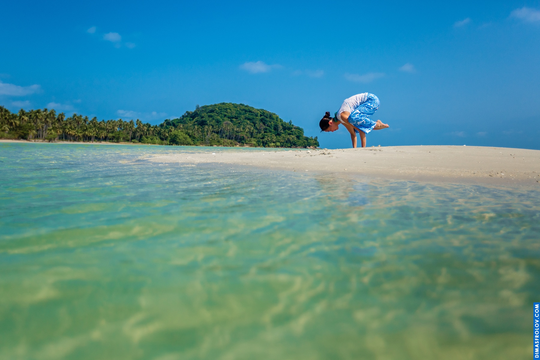 Secluded beach tranquility: paddleboard floating in clear shallow water