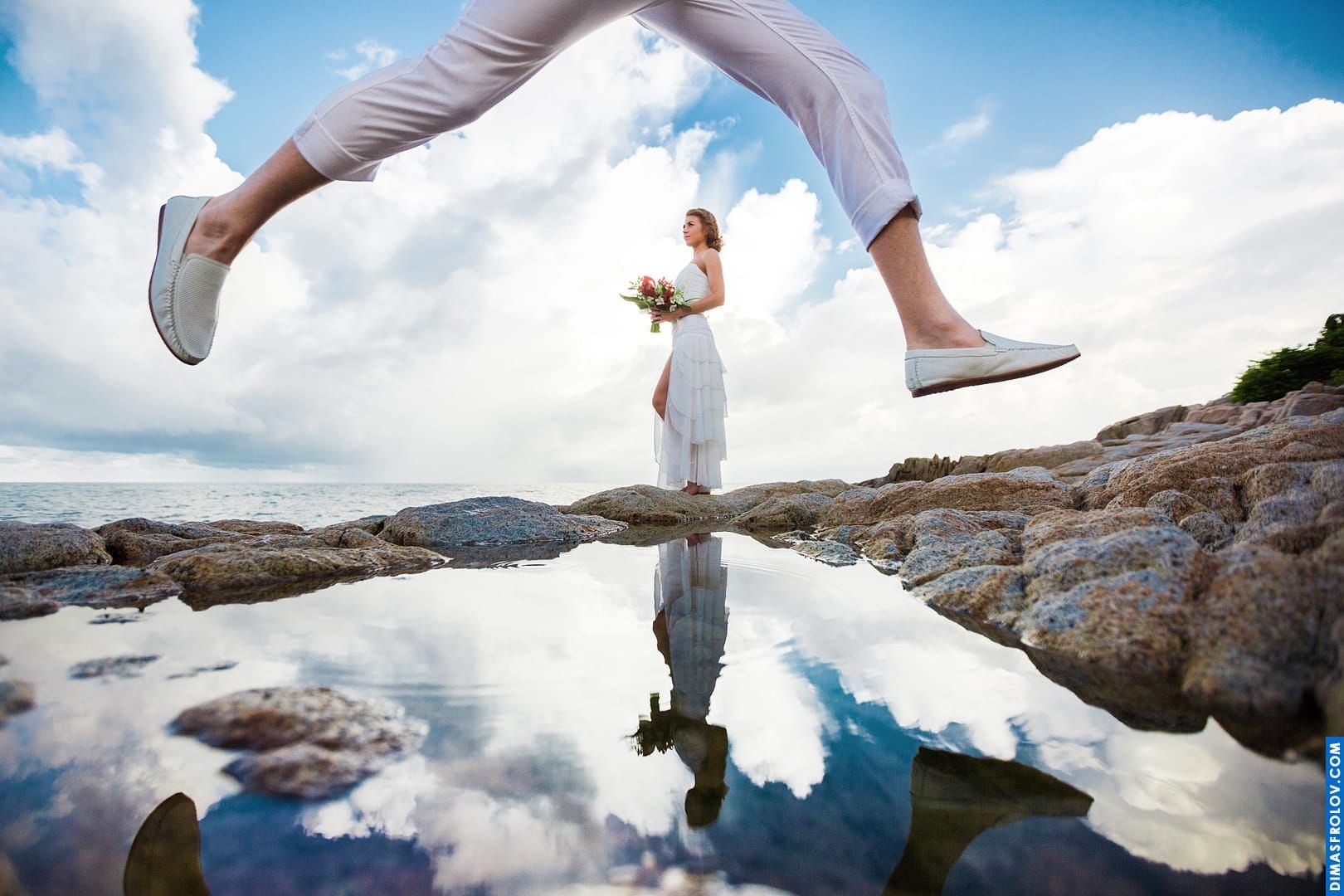 Creative wedding shot with reflection and playful framing — bride and groom in one unique frame