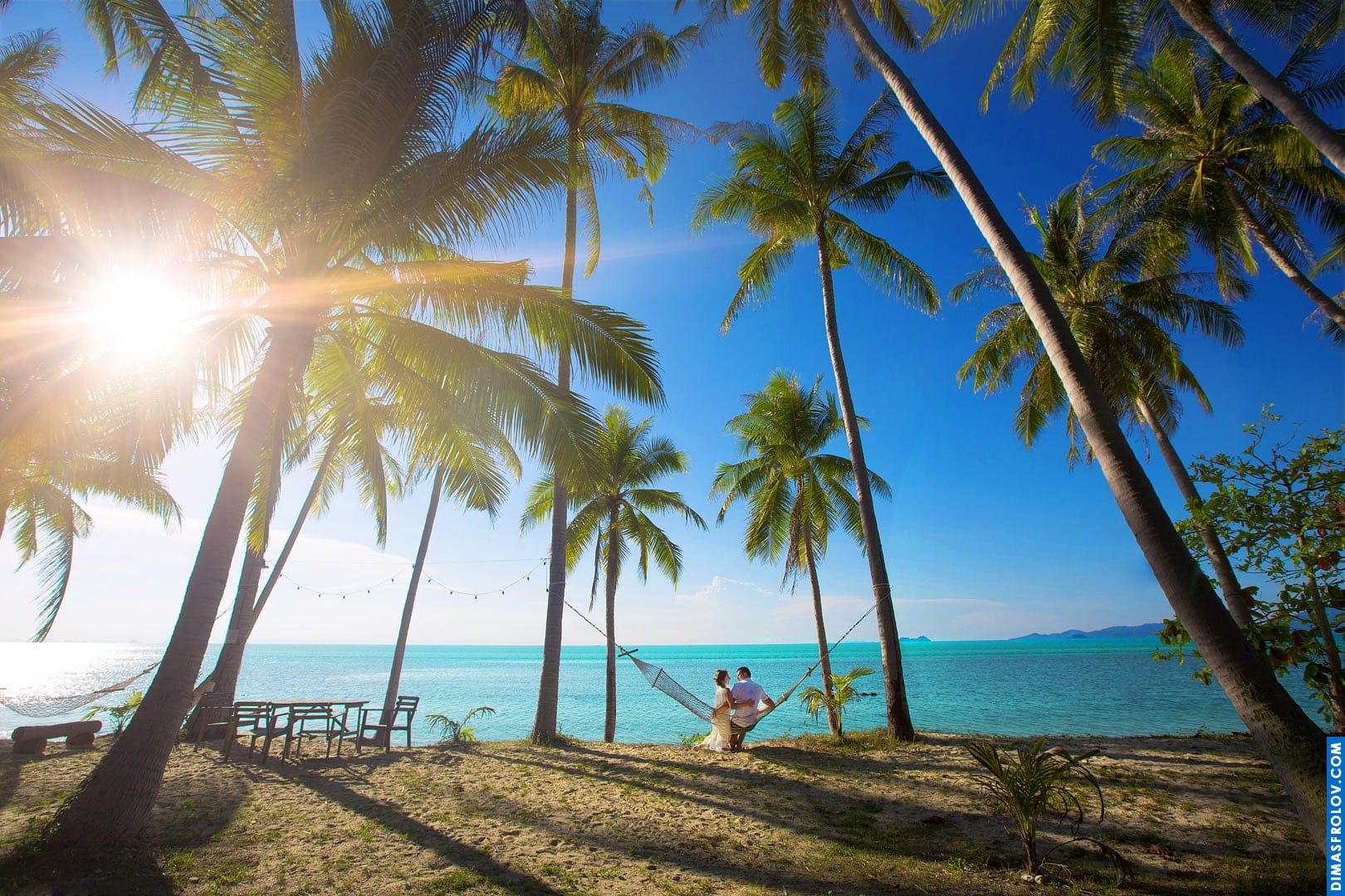 Wedding couple relaxing on a swing by the sea — peaceful tropical photoshoot