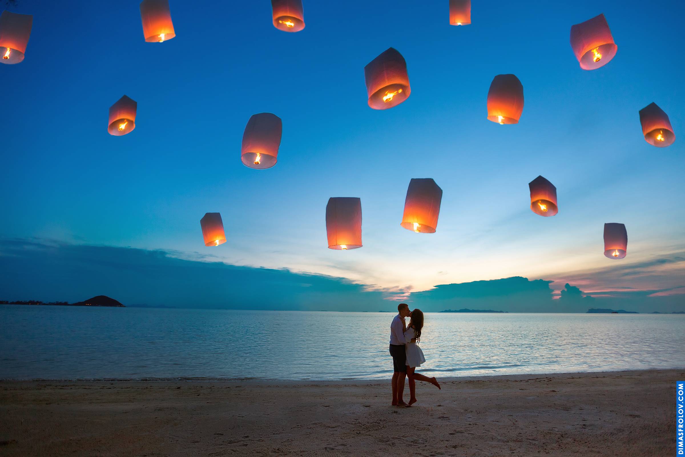 Romantic couple photo with sky lanterns at twilight