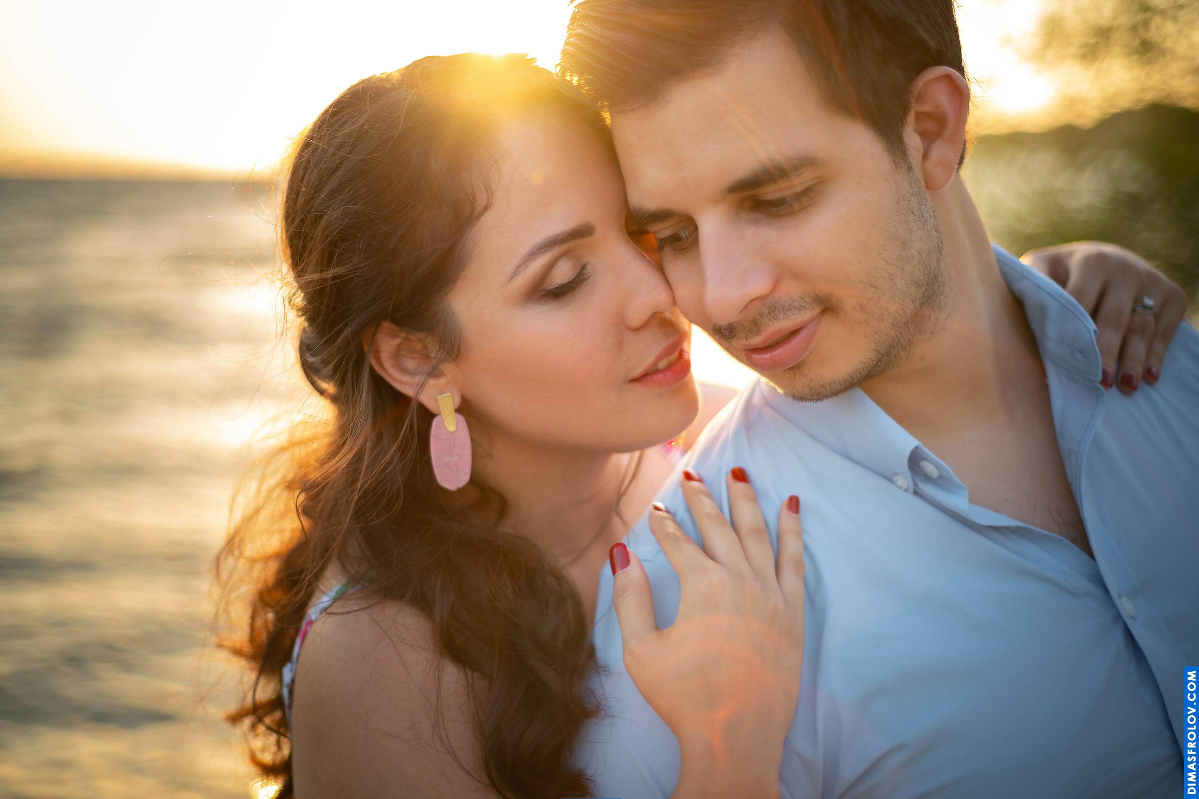 Soft sunset light on a close-up love story moment at the beach