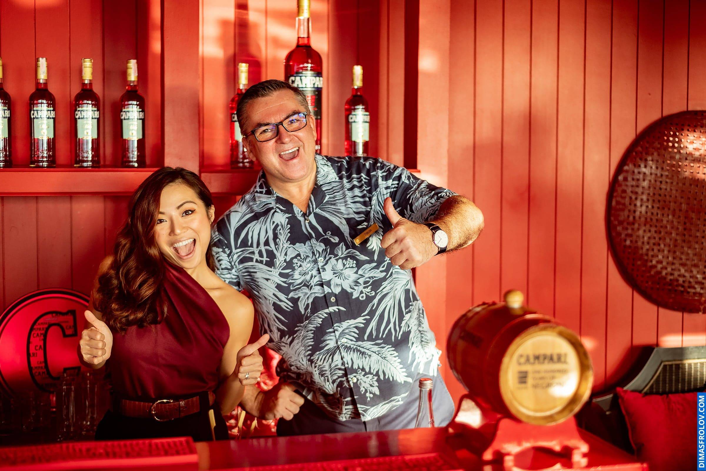 Friends posing in stylish event bar — relaxed vibe with cocktails and smiles