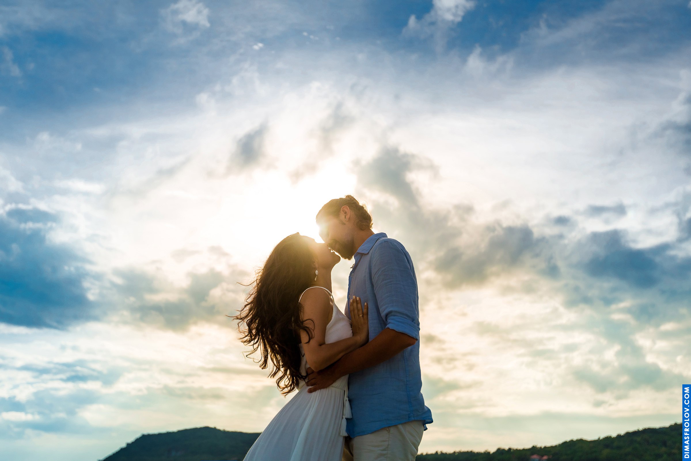 Sunset couple photo with sun flare and soft embrace