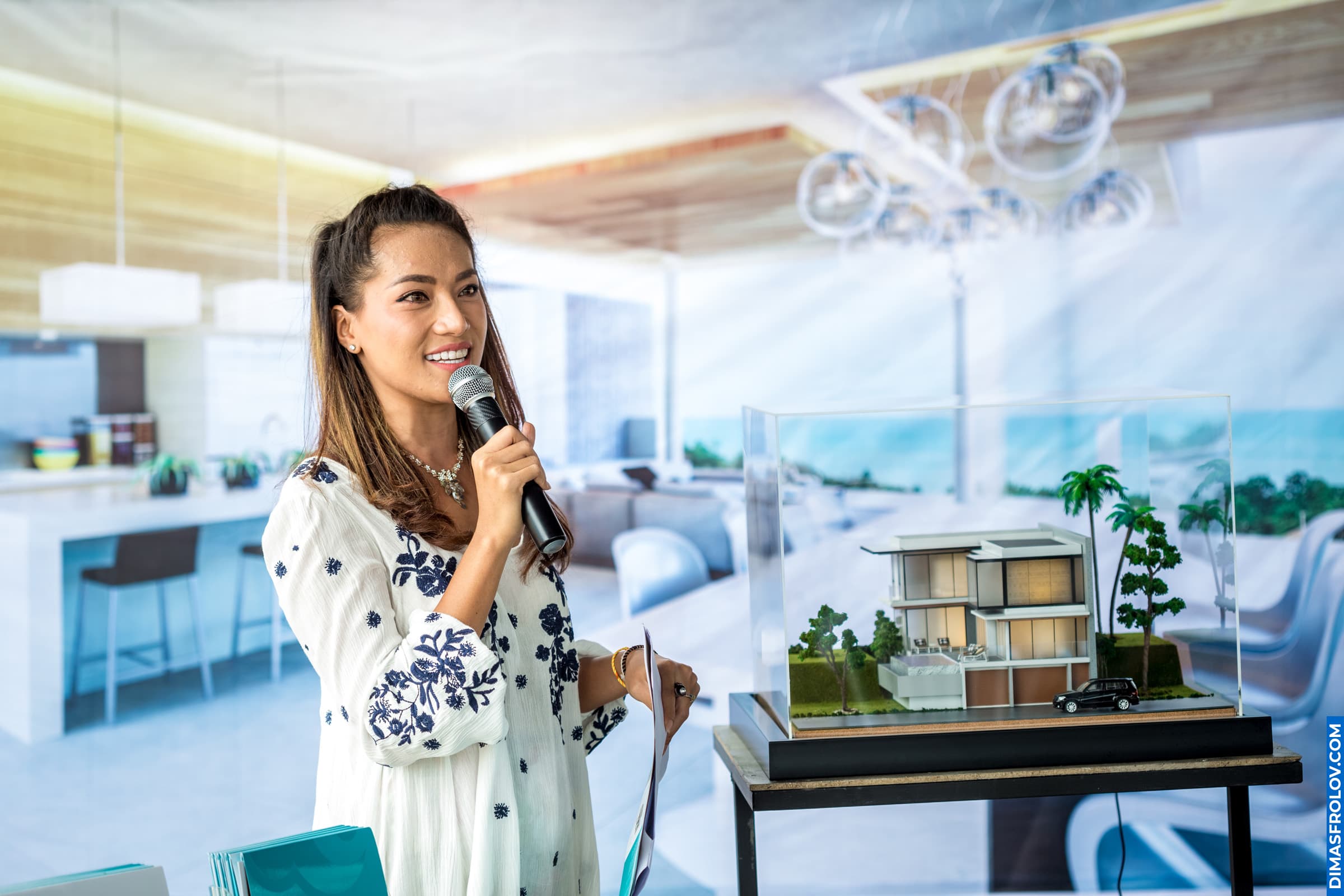 Interior designer presenting project model at luxury property launch event