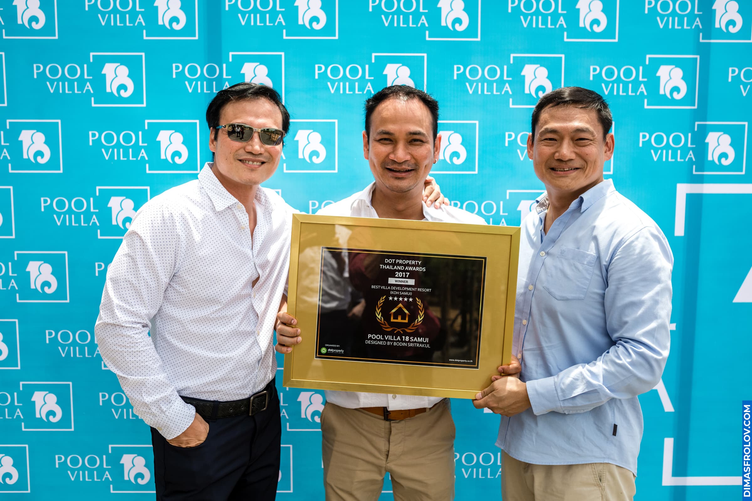 Award ceremony during real estate event — developers receiving recognition plaque