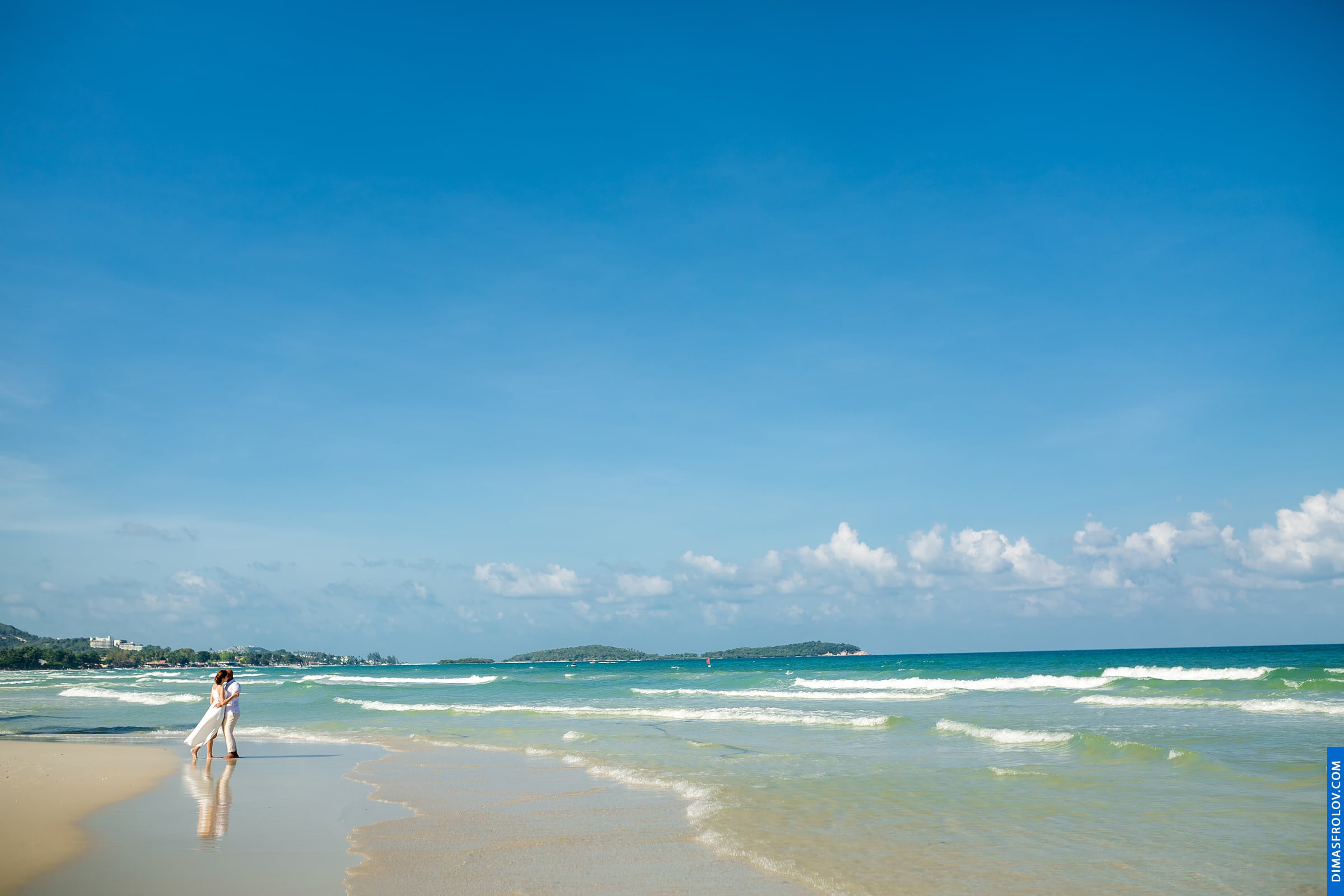 Bridal portrait with wide beach view and turquoise waves in the distance