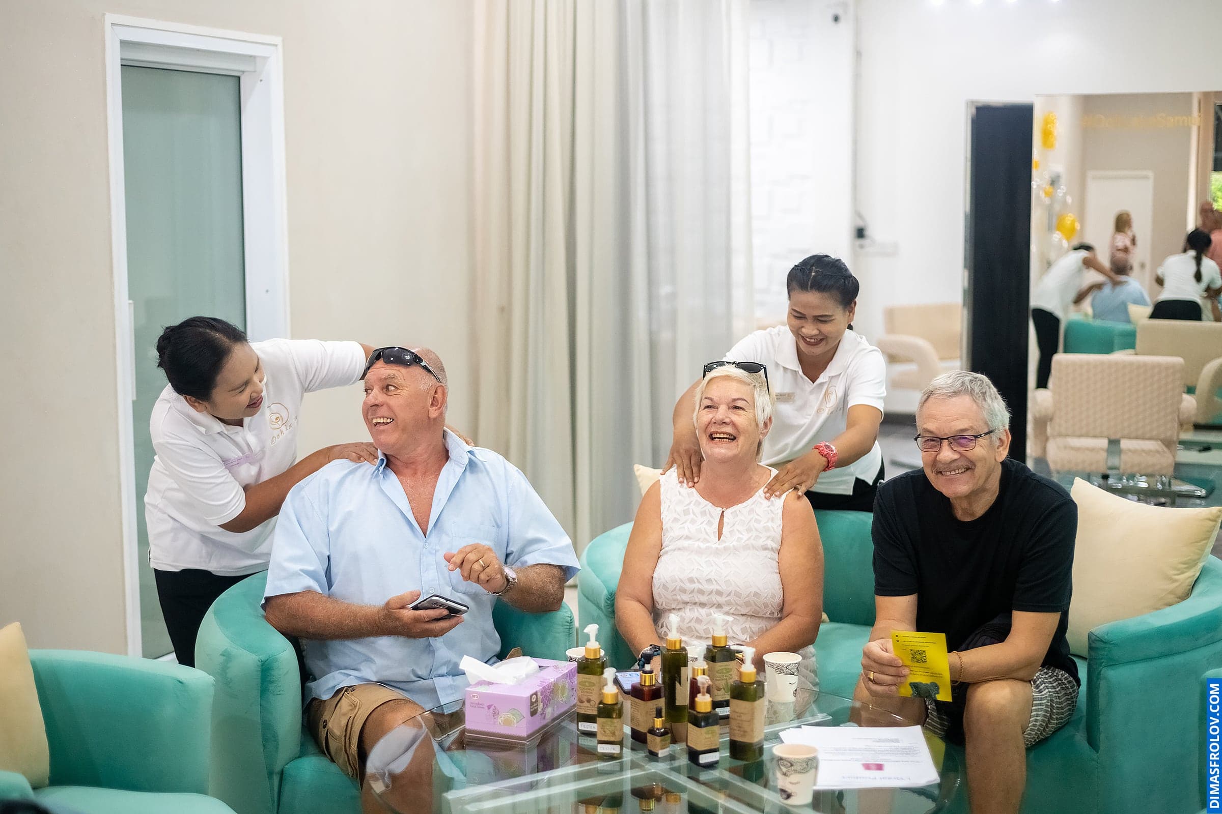 Grand opening event at spa salon — guests relaxing with welcome treatments and smiles