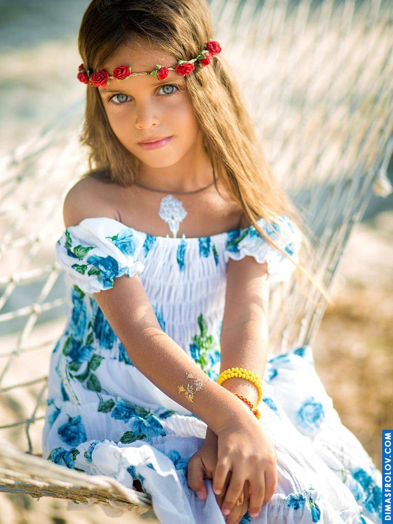 Styled kids portrait — girl in floral dress and flower crown in hammock