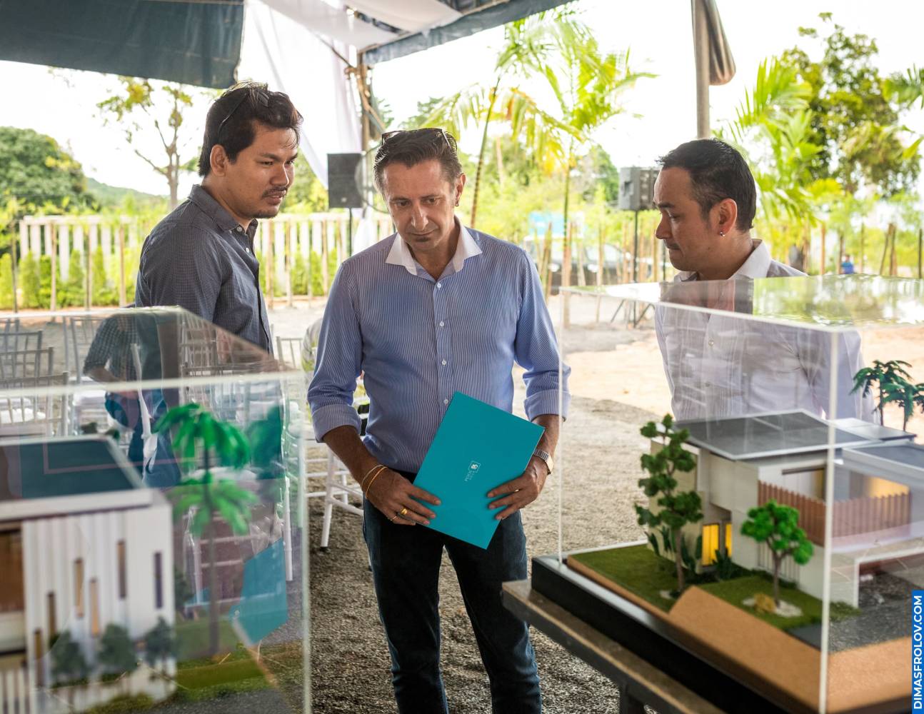 Guests discussing real estate scale models with developers and architects