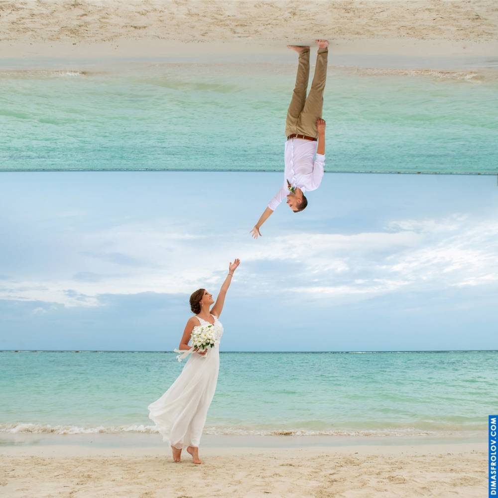 Surreal wedding photo — bride reaching for groom upside-down on mirrored horizon