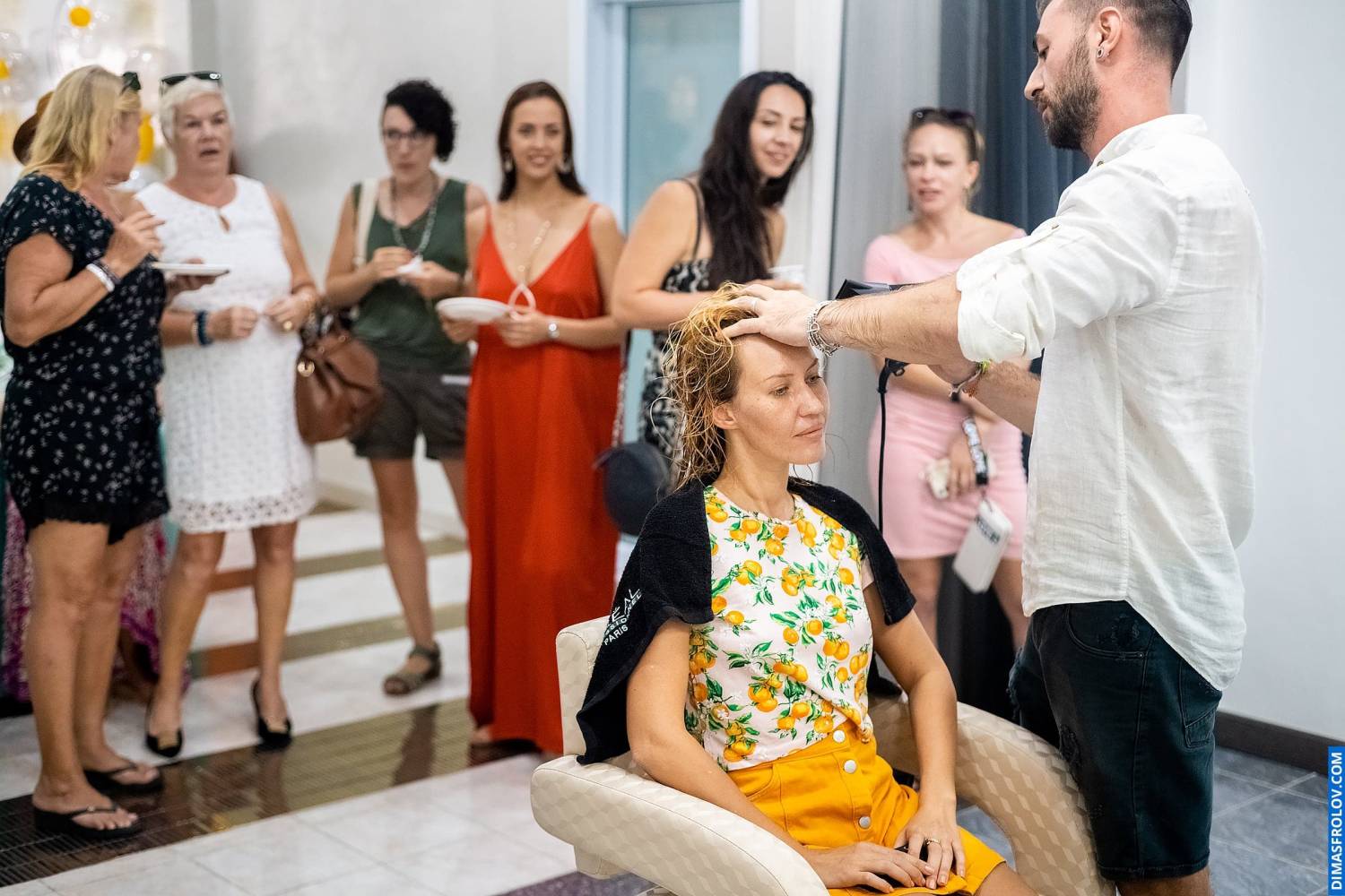 Spa presentation — guests discussing services and exploring products inside salon