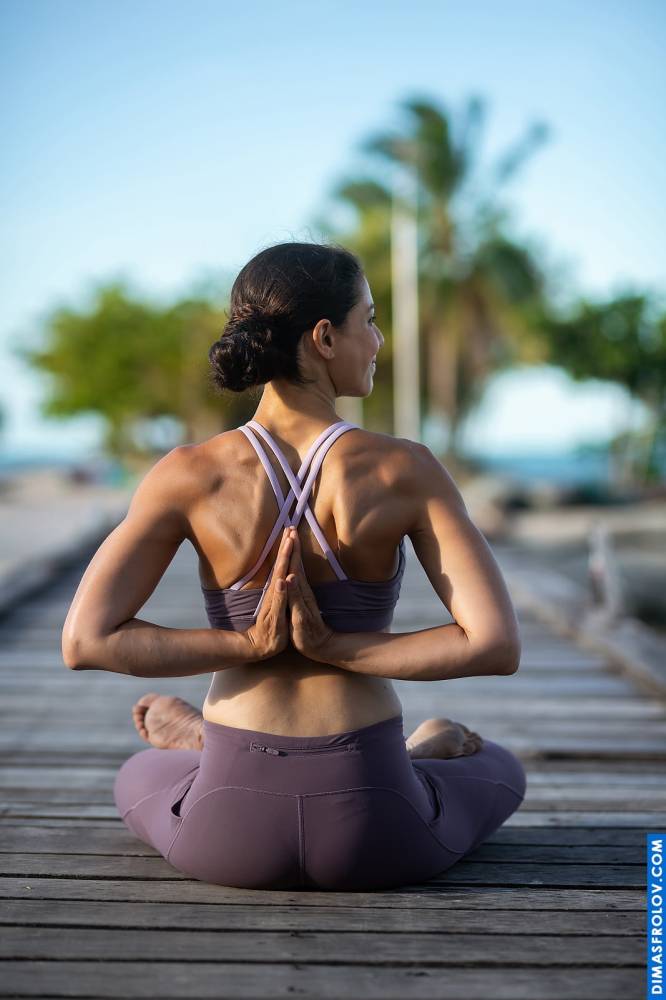 Mindful yoga practice: woman in a seated pose with hands in reverse Namaste