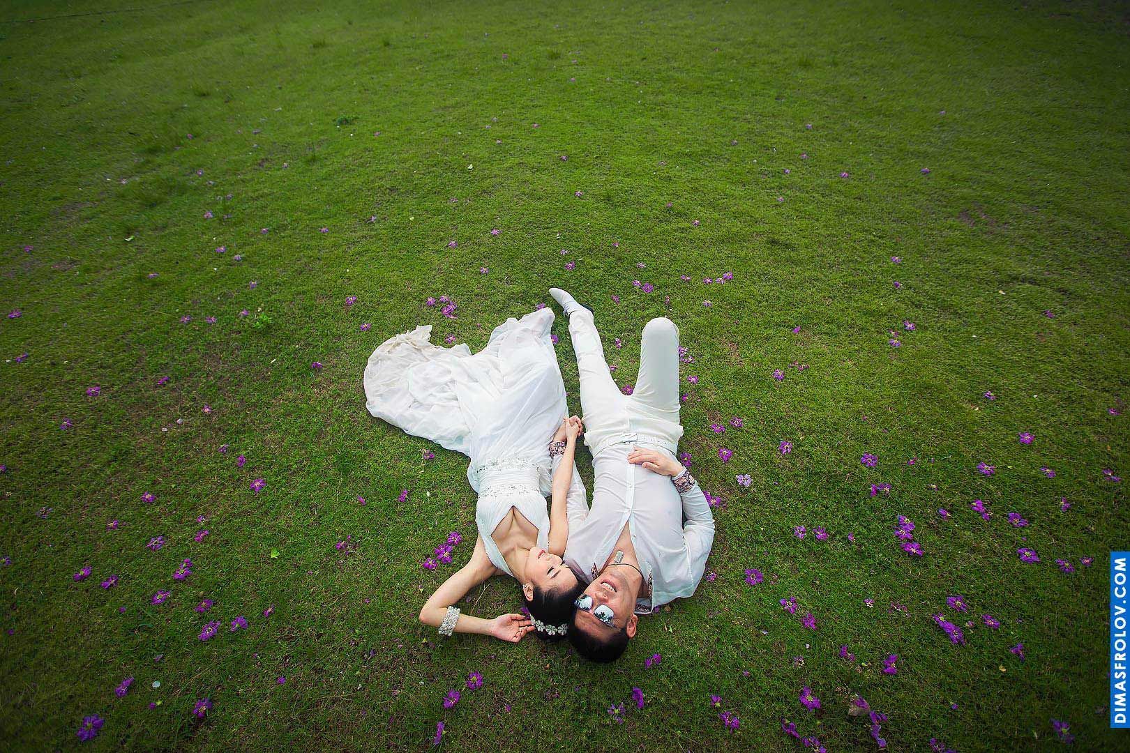 Koh Samui Wedding Photographer. Wedding couple laying on the grass. Photo from the sky Dimas Frolov. Koh Samui Photographer. DimasFrolov.com