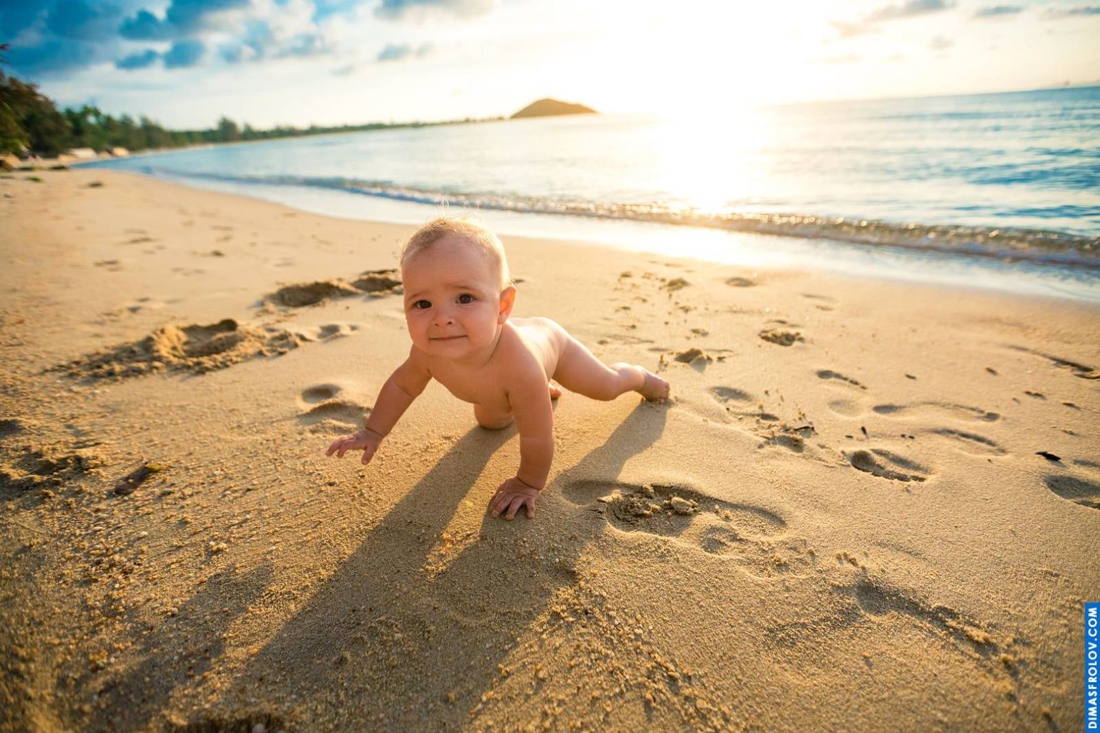 Baby crawling on the beach at sunset — golden light and tiny hands