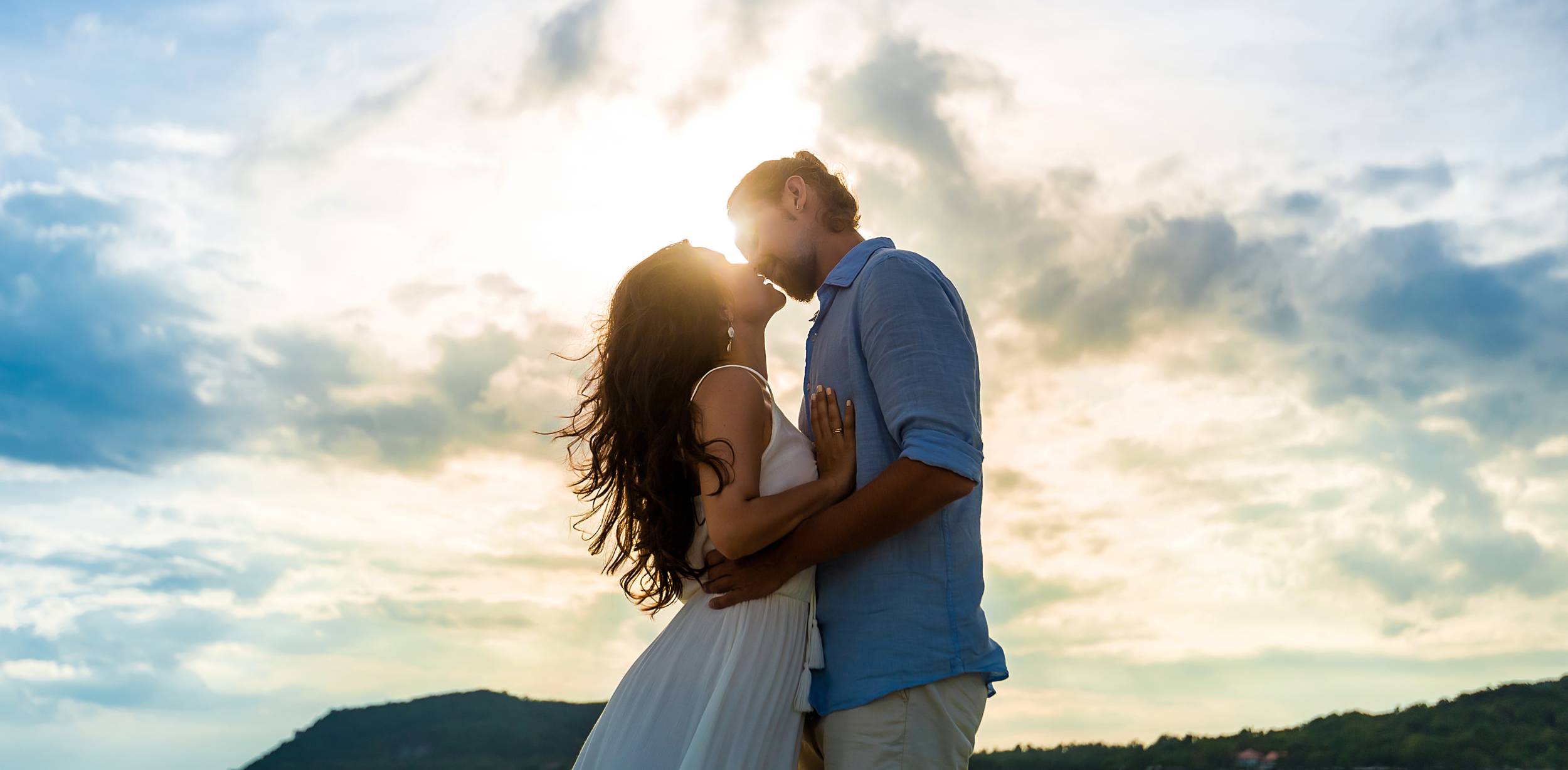 Romantic photo by a Lisbon photographer capturing an affectionate moment between a couple from Miradouro das Portas do Sol