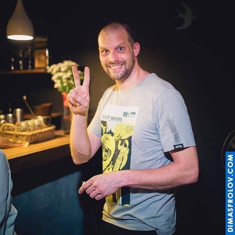 Guest posing at restaurant birthday party with a smile and peace sign